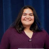 Woman smiling with a certificate